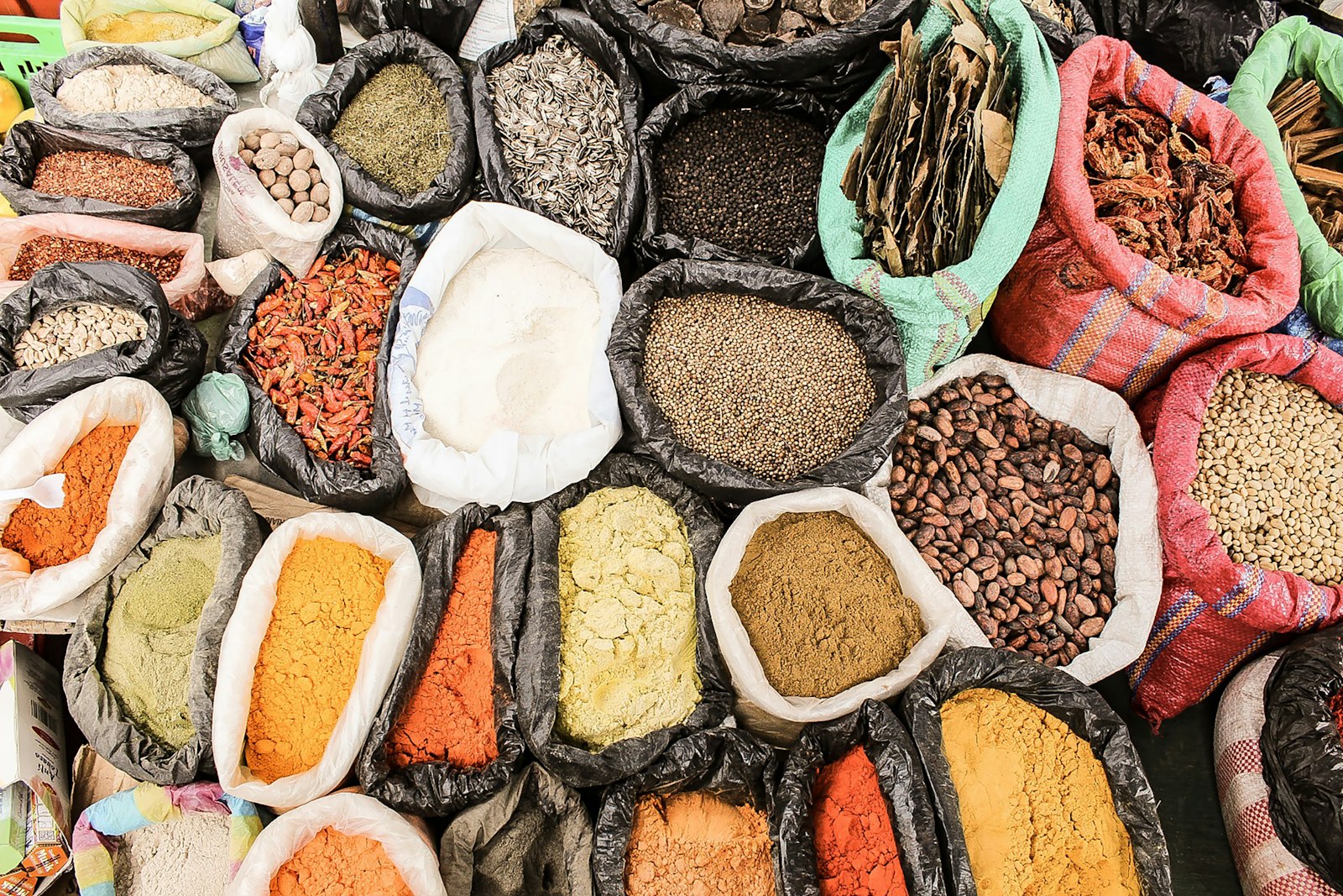 Sacks of whole spices and seeds at a traditional spice market