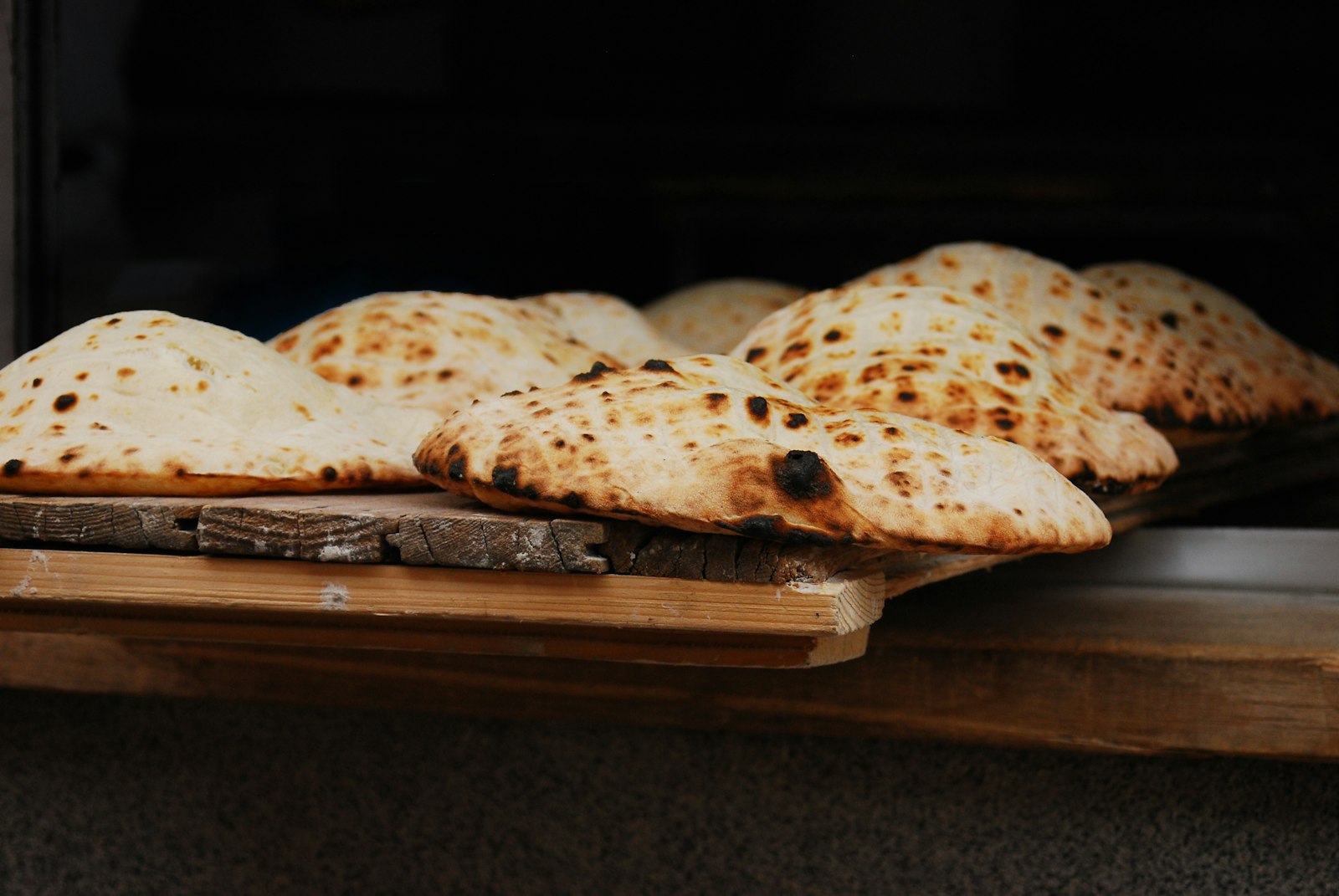 A rustic round loaf baked over an open fire