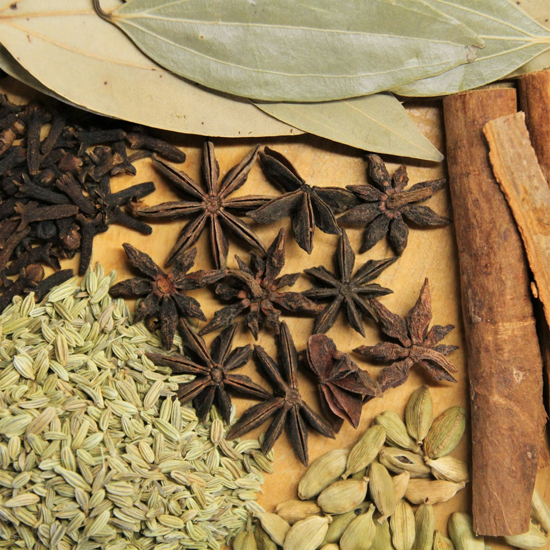 A warm flatlay of dried herbs and spices on wood — placeholder while brand photography is in production