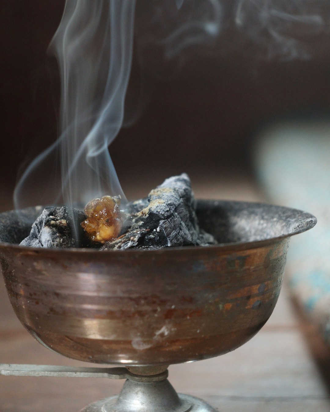Incense smoldering over hot coal in a round burner — placeholder editorial photo, replace with brand shot