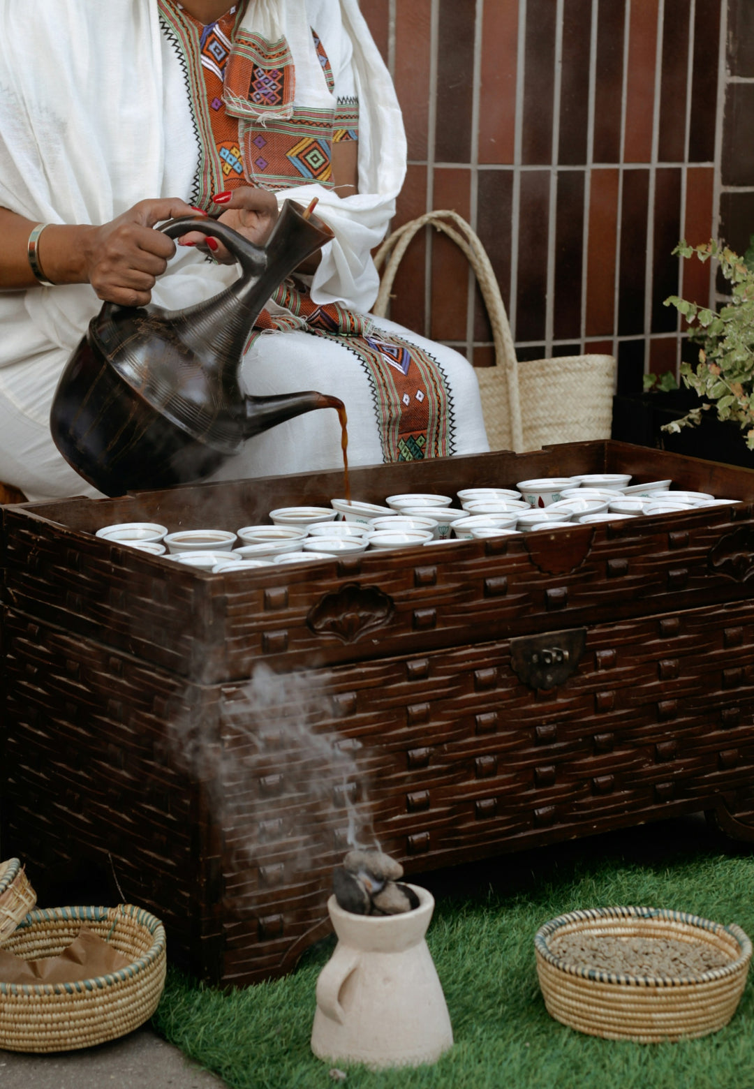 Ethiopian coffee ceremony — jebena pouring into sini cups